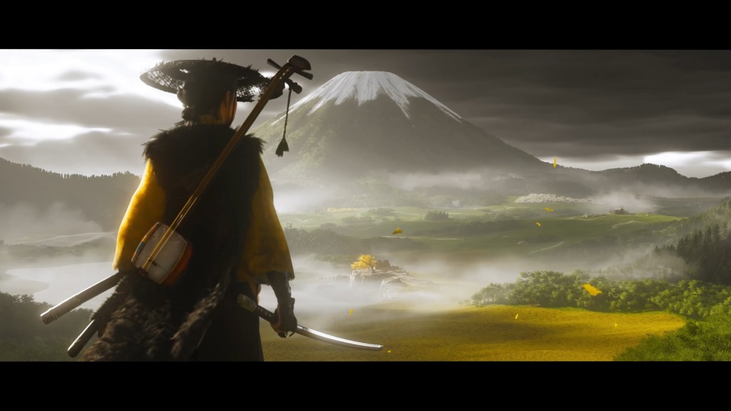 A samurai dressed in traditional attire stands on a hill overlooking a vast landscape with a mountain in the background and mist floating over the fields.