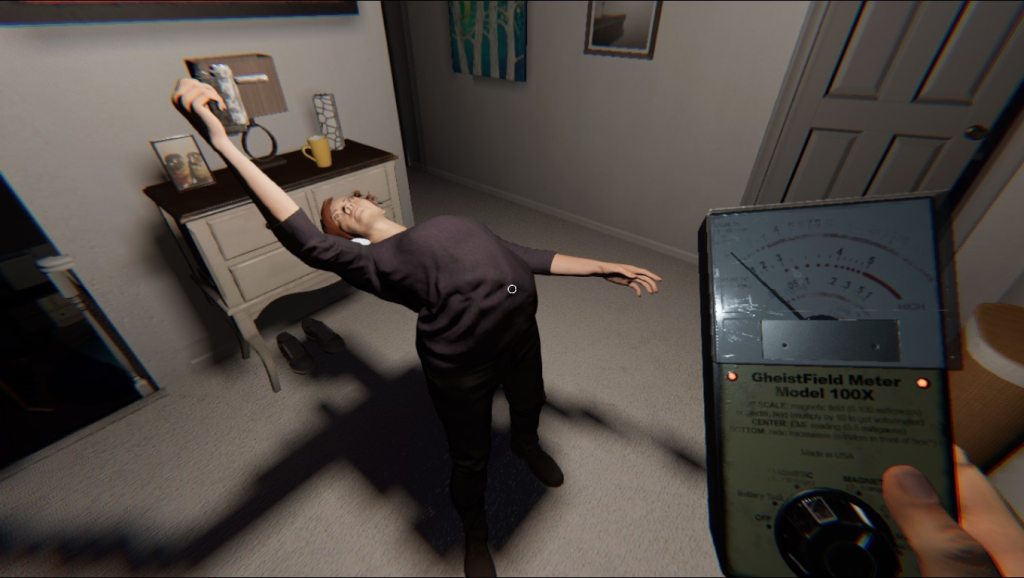 A character in a horror game holds a ghost detector while appearing to be in distress, with a shadowy figure in the background.