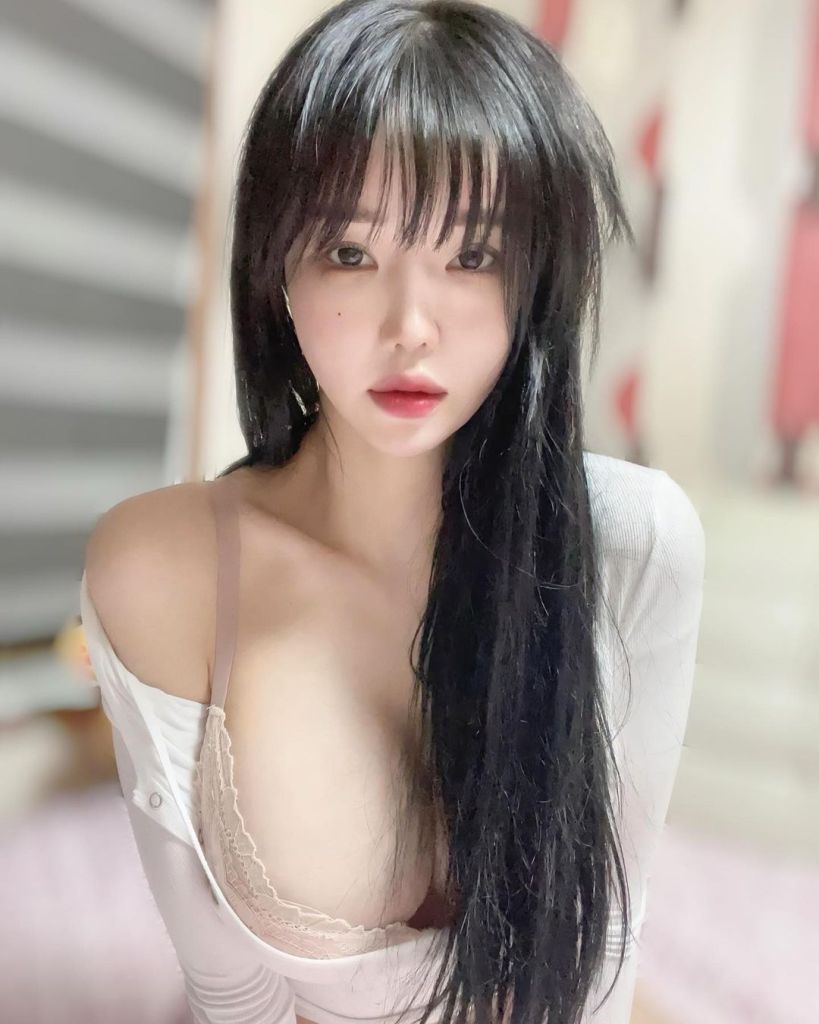 來自南韓的模特兒Mimi在房間中拍攝，穿著白色上衣，臉部特寫展現出優雅的神情和長髮。